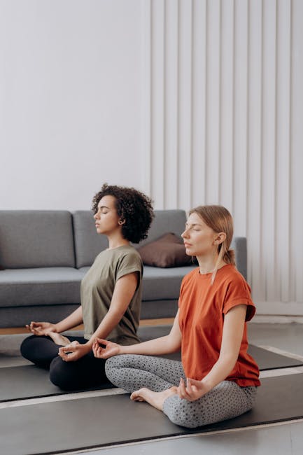 Woman practicing gentle yoga on a mat in a bright, modern living room